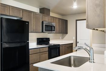 an empty kitchen with a sink and a refrigerator at Altitude, Washington